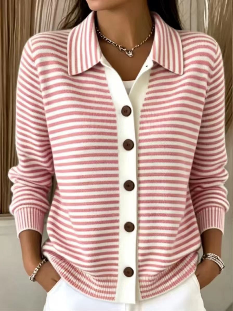 A woman wearing a pink and white striped knit cardigan with a white collar and brown buttons, layered over a white top.