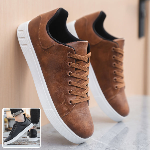 Brown leather sneakers with white soles on a light background