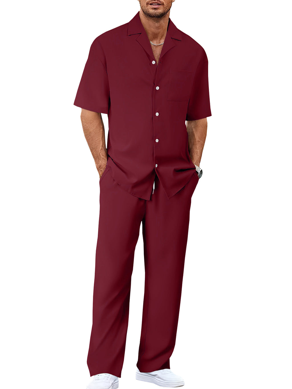 Man wearing a maroon shirt and pants on a white background