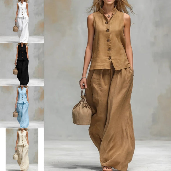 Woman wearing a brown sleeveless top and wide-leg pants holding a matching handbag on a plain background.