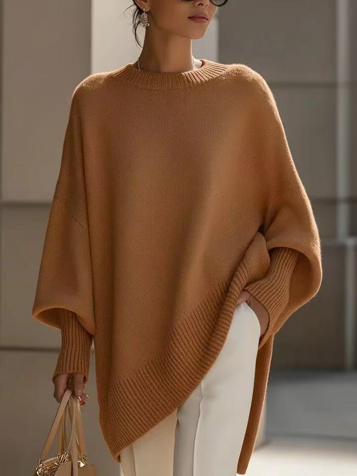 Person wearing a brown poncho in an indoor setting