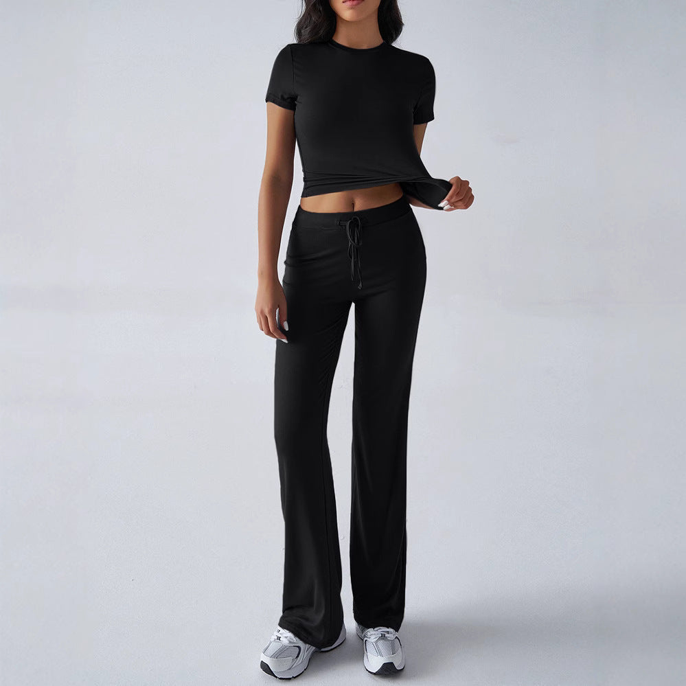 Person wearing a black outfit on a plain background