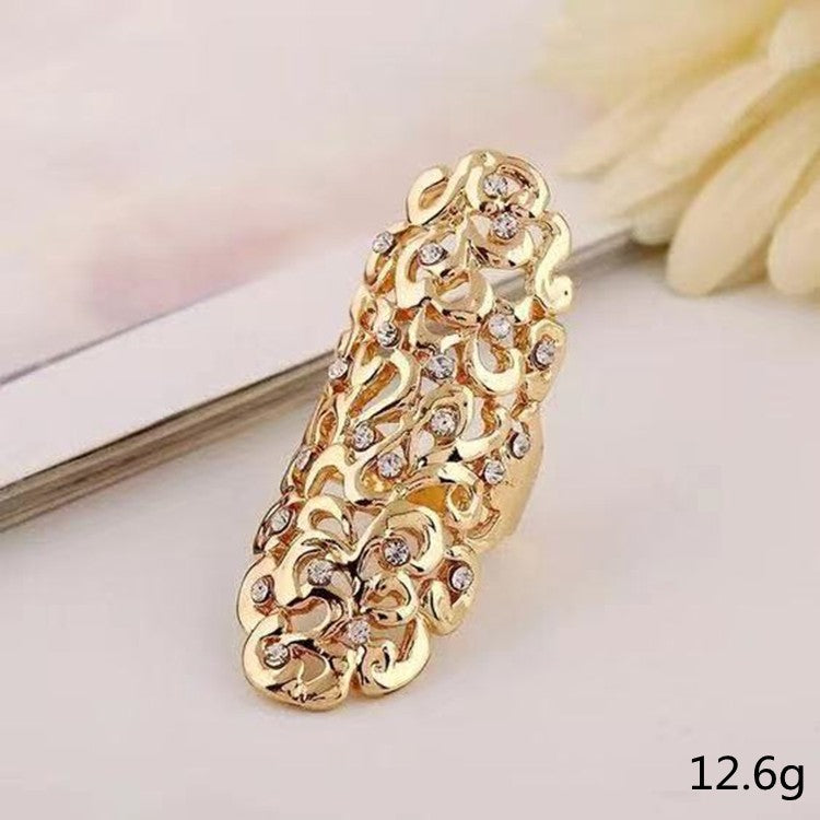 Gold bracelet with intricate design on a light background