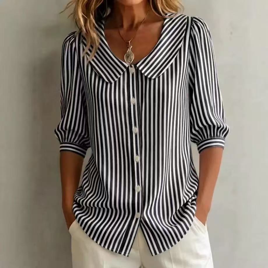 Black and white striped shirt worn by a person against a plain background