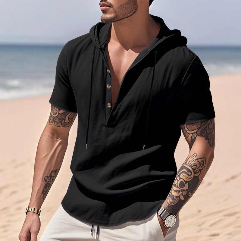 Man wearing a black hoodie on a beach
