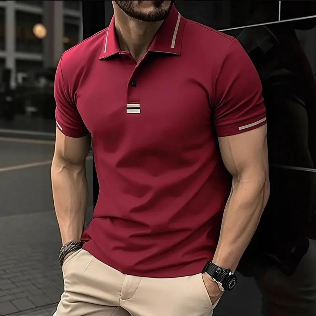Man wearing a red polo shirt with a black car in the background
