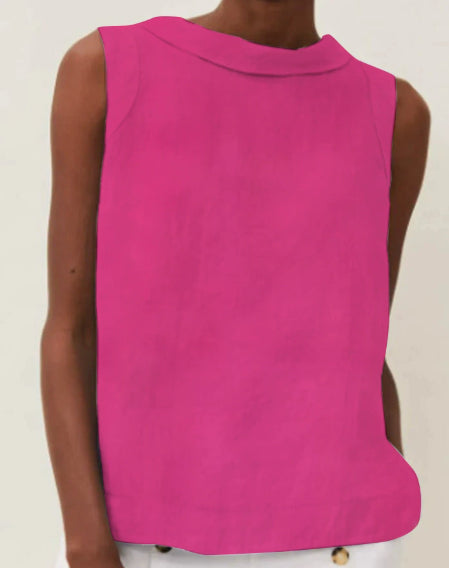 Person wearing a bright pink sleeveless top on a plain background