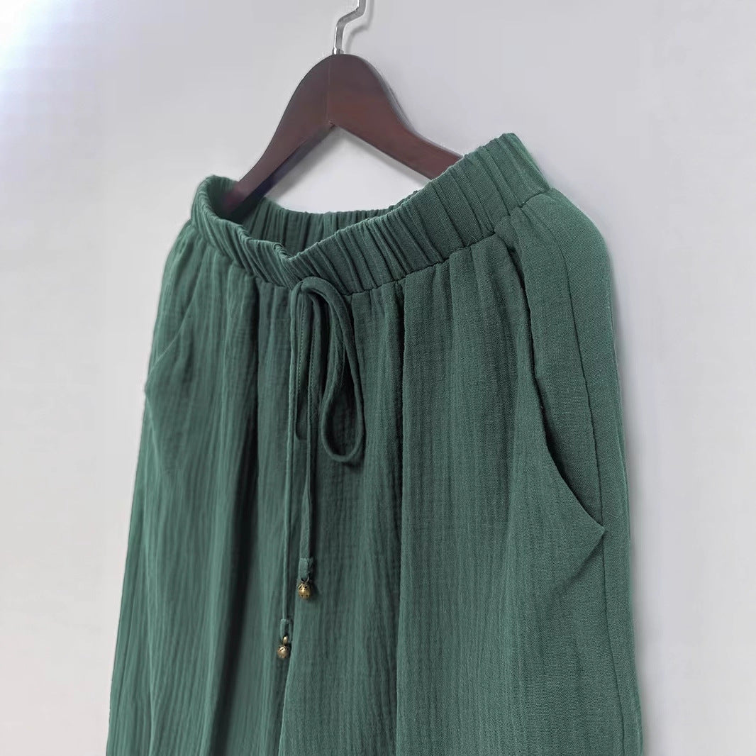 Green skirt on a hanger against a white background