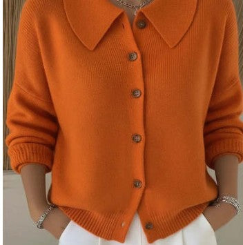 Orange knitted cardigan with buttons on a neutral background