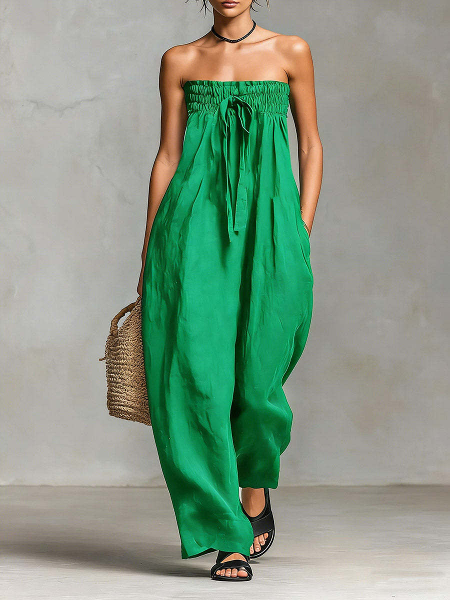 Green strapless dress worn by a person against a neutral background