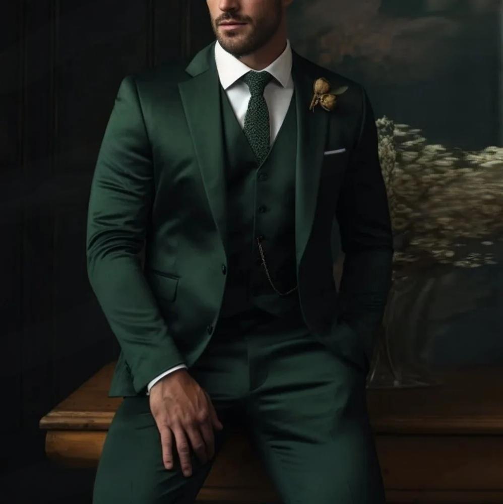 Man in a green suit sitting on a wooden bench against a dark background
