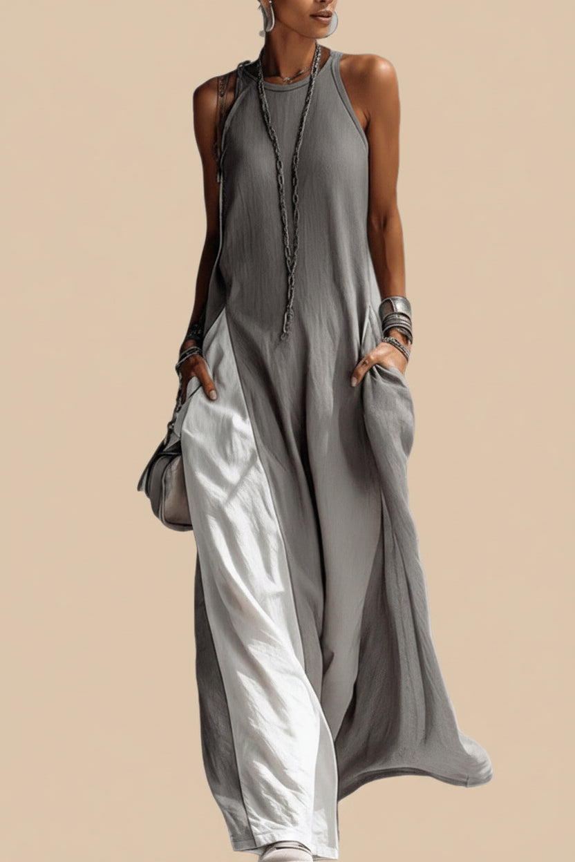 Woman wearing a long gray dress with a white background