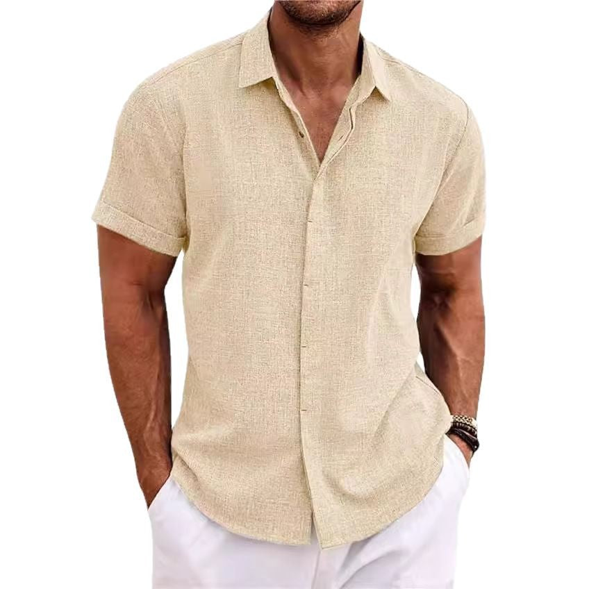 Man wearing a beige short-sleeve shirt and white pants on a white background