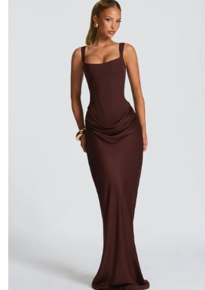 Woman wearing a brown evening gown on a white background