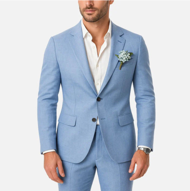 Man wearing a light blue suit with a white shirt and floral boutonniere on a white background