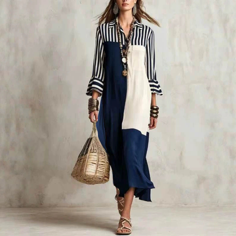 Woman wearing a black and white striped shirt with a blue and white dress, holding a woven bag against a neutral background.