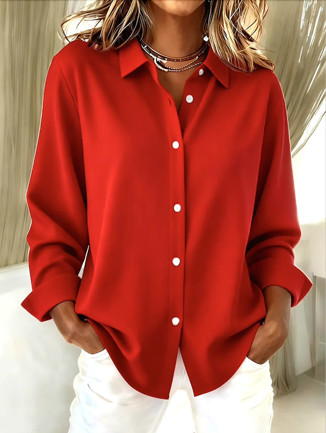 Red button-up shirt worn by a person with a neutral background