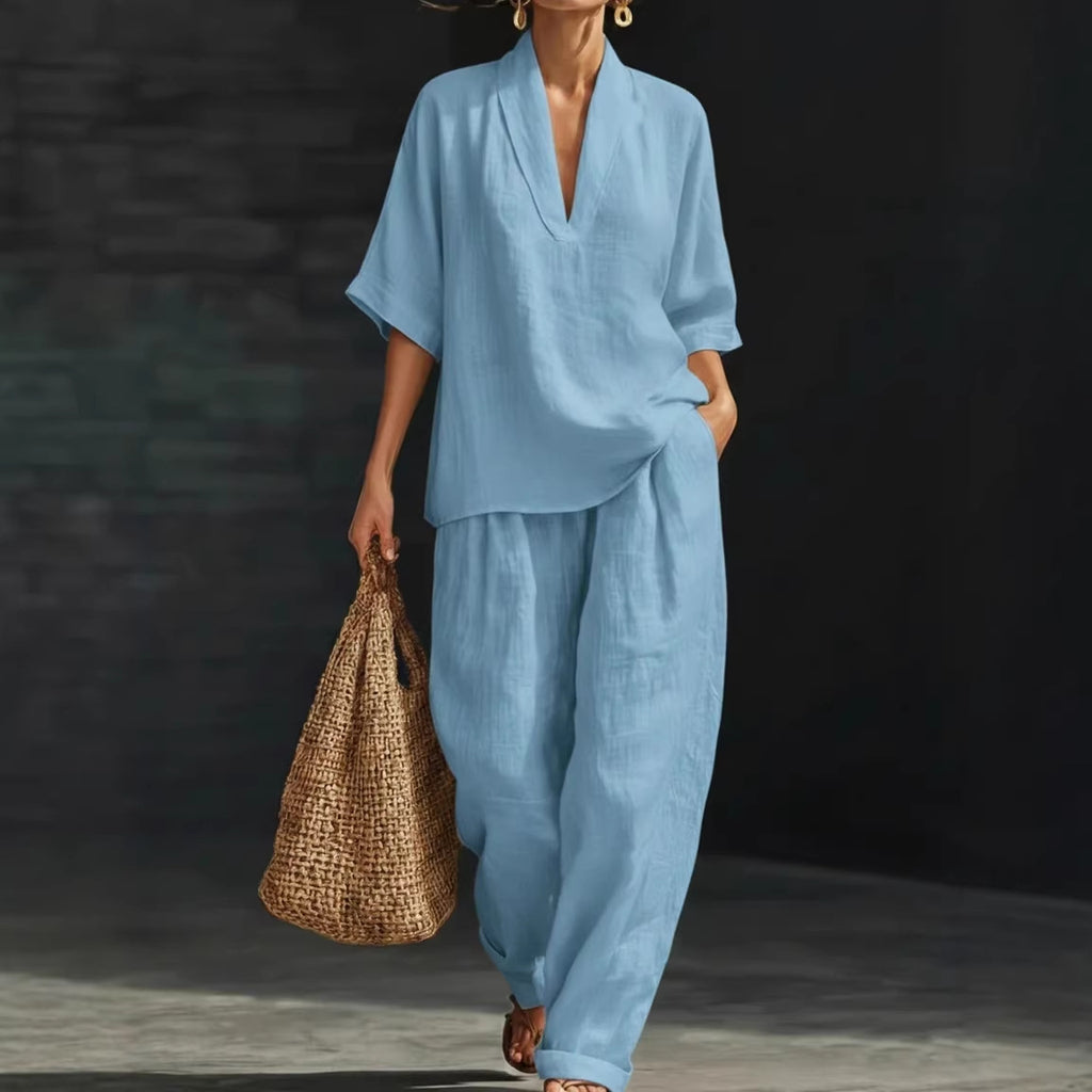 Person wearing a blue outfit holding a woven bag against a dark background