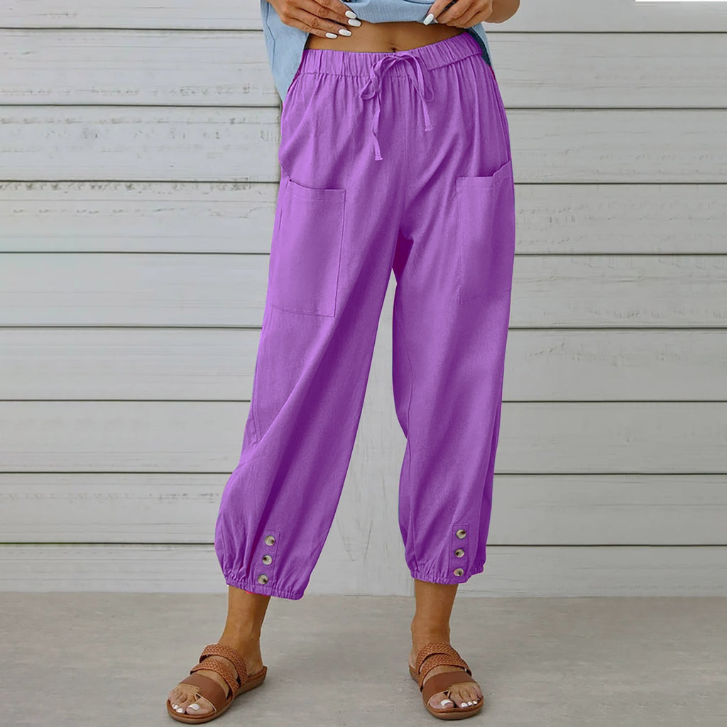 Purple pants worn by a person against a wooden background