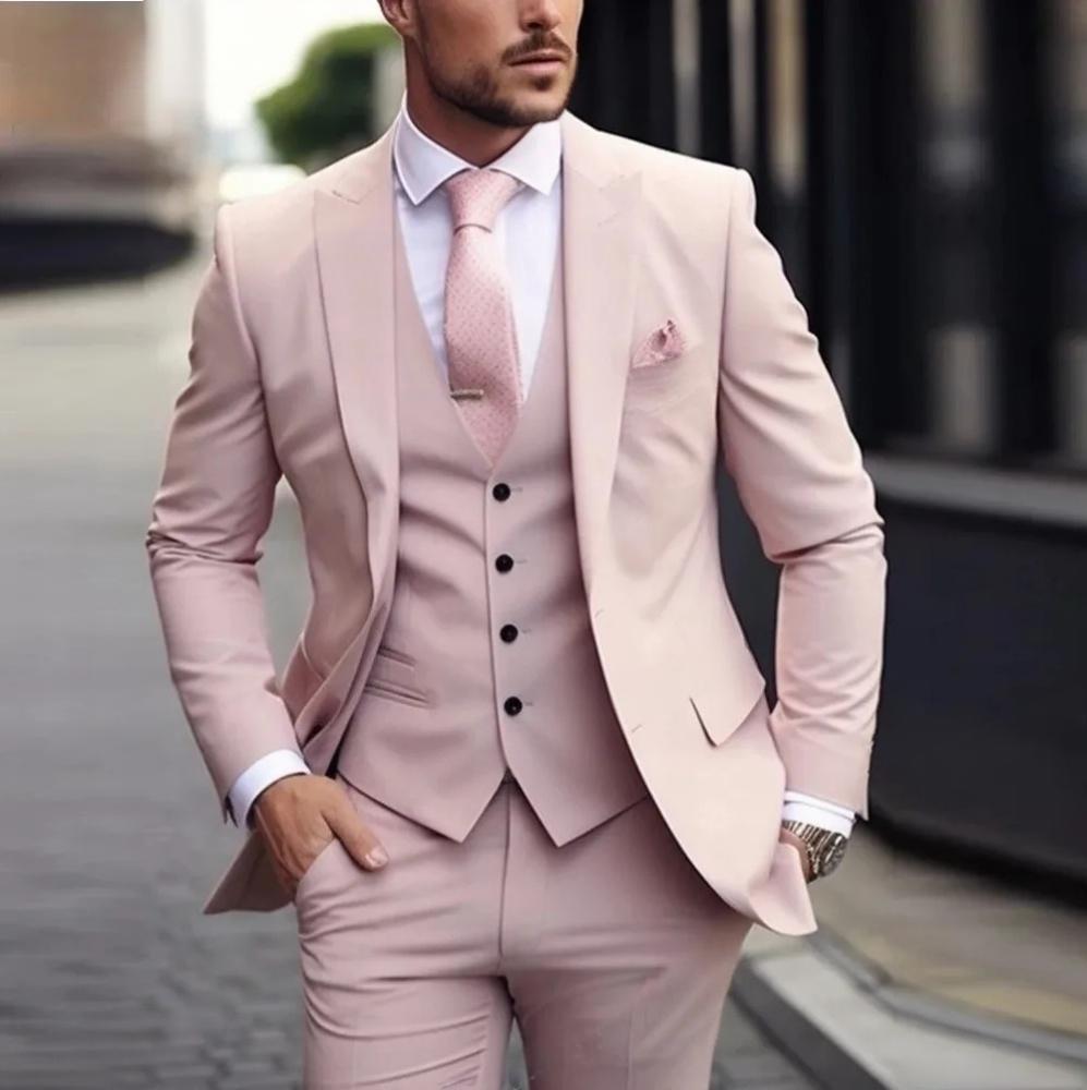 Man wearing a light pink suit with a blurred background