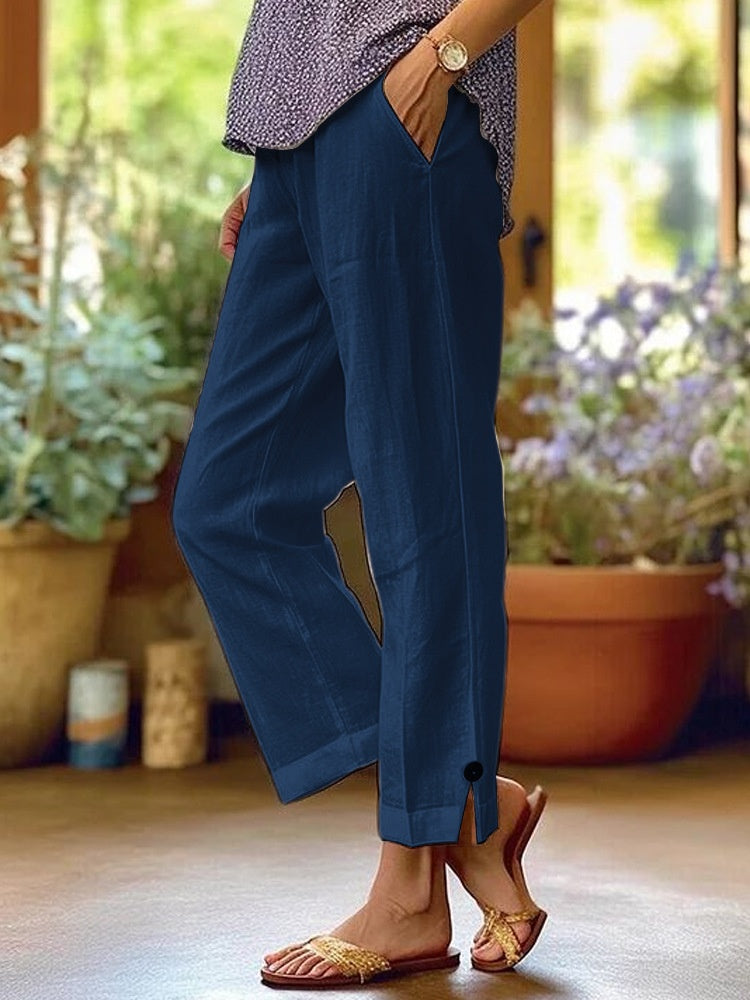 Person wearing blue pants with a blurred indoor background