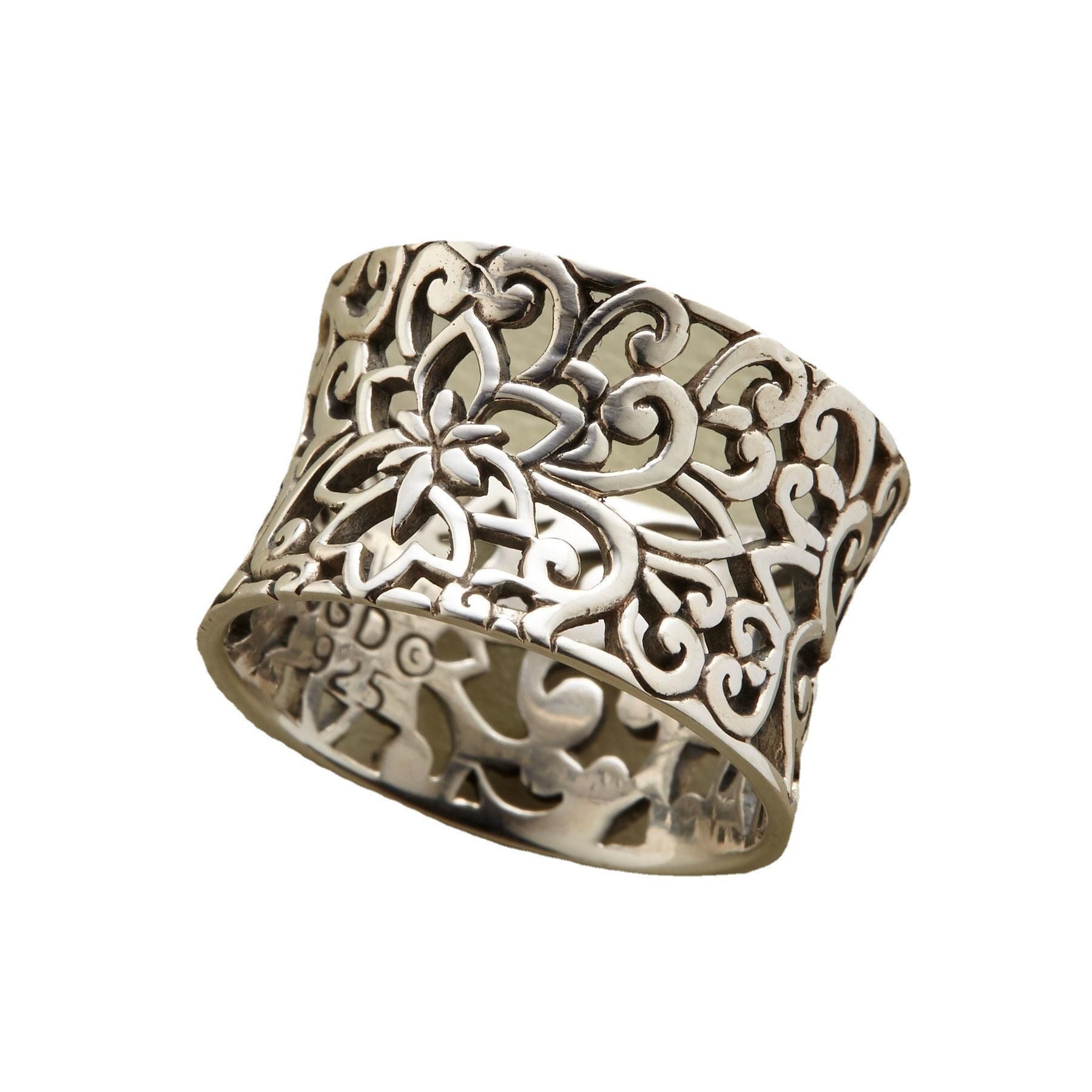 Silver filigree ring on a white background