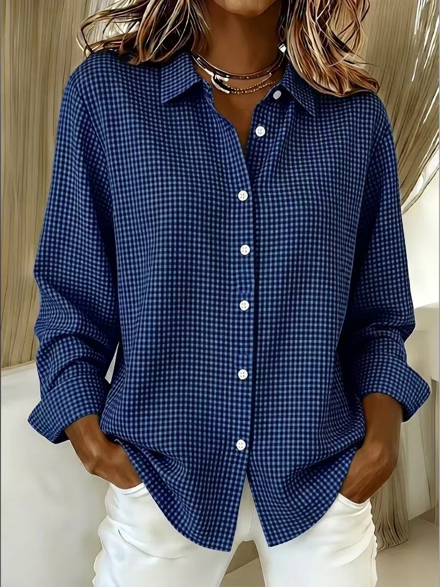 Person wearing a blue checkered shirt with white pants indoors