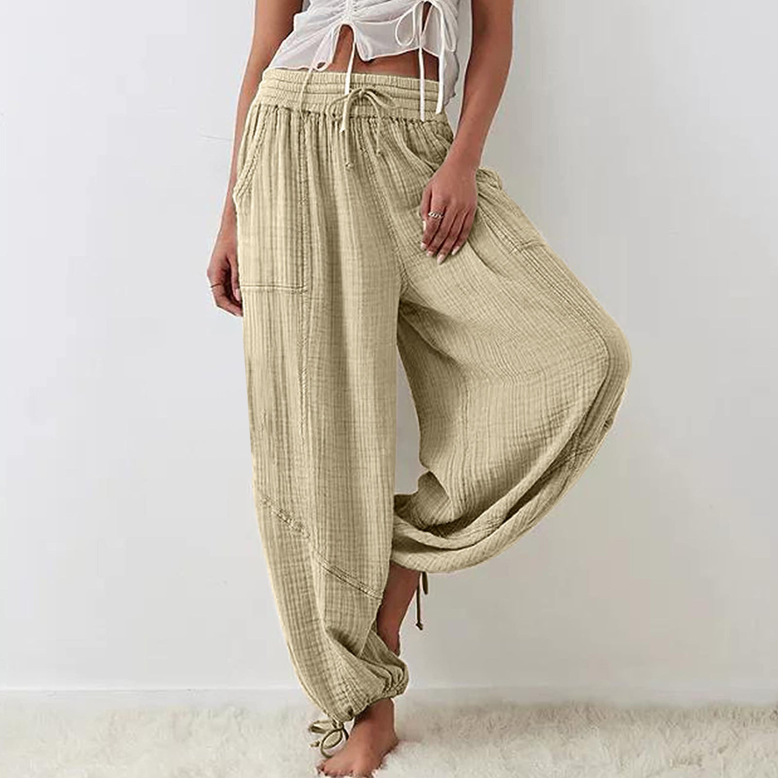 Beige wide-leg pants worn by a person on a white background