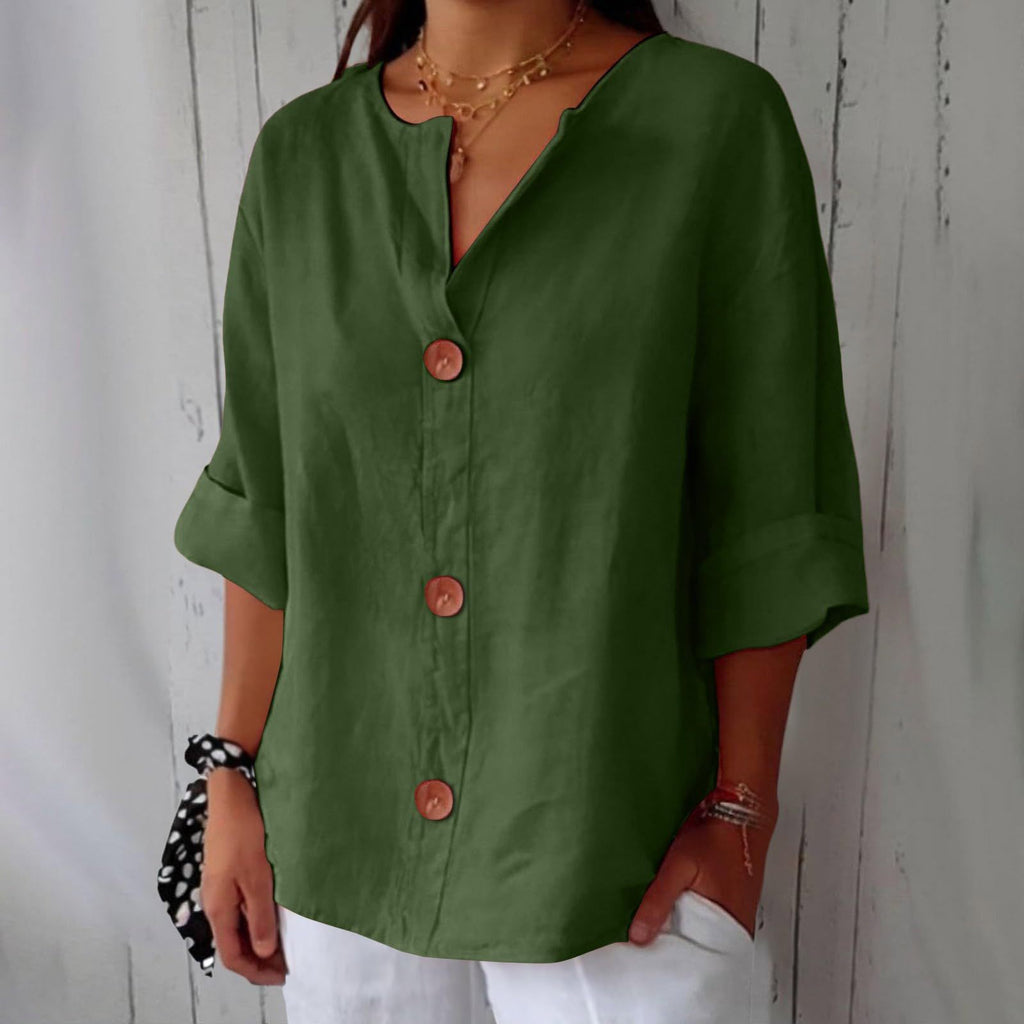 Person wearing a green button-up shirt with a white background