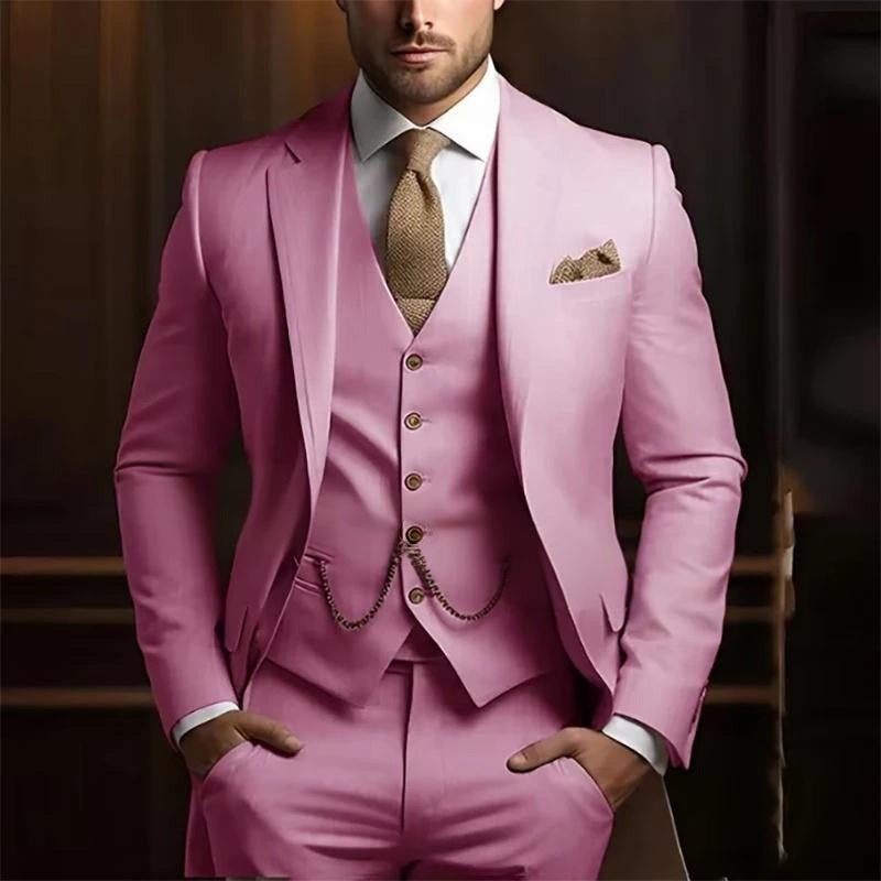 Man wearing a pink suit with a brown tie and pocket square against a blurred background