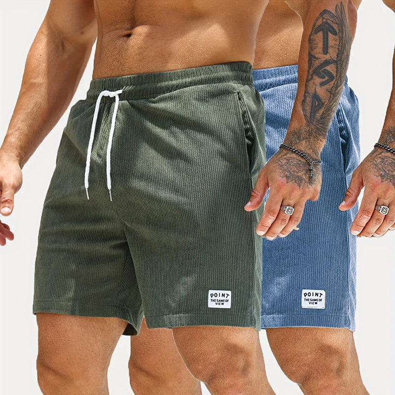Two pairs of men's shorts, one green and one blue, with visible brand logos.
