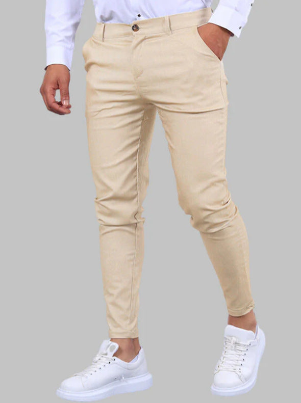 Beige pants worn by a person on a gray background