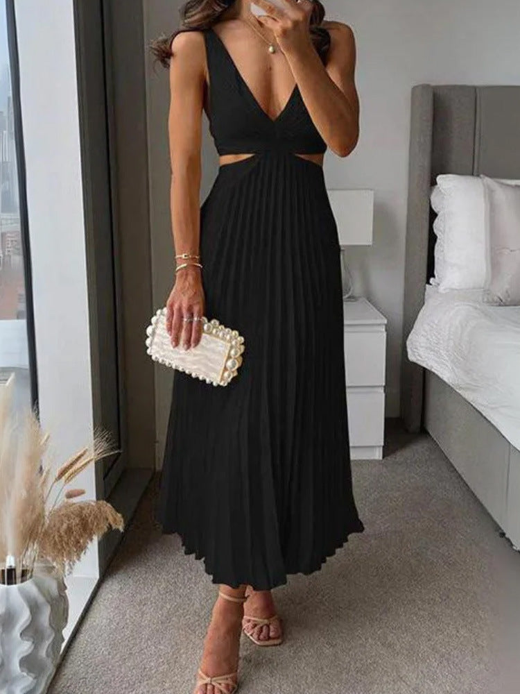 Woman in a black dress holding a pearl clutch in a bedroom setting