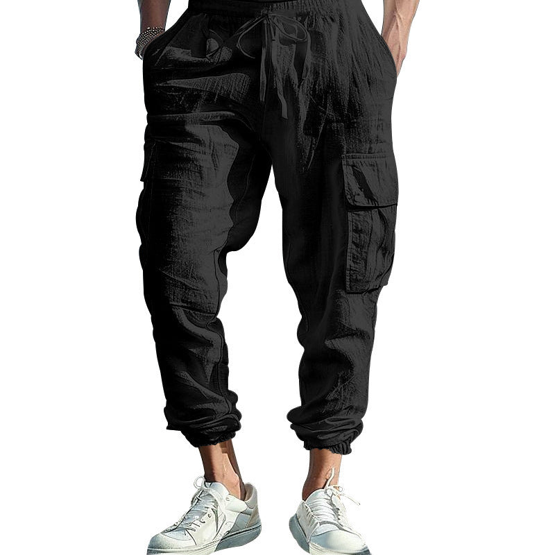 Black cargo pants worn by a person on a white background