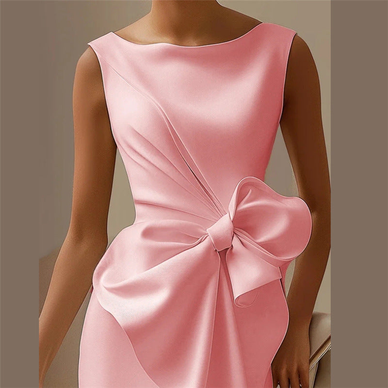 Pink dress with a large bow detail on a neutral background