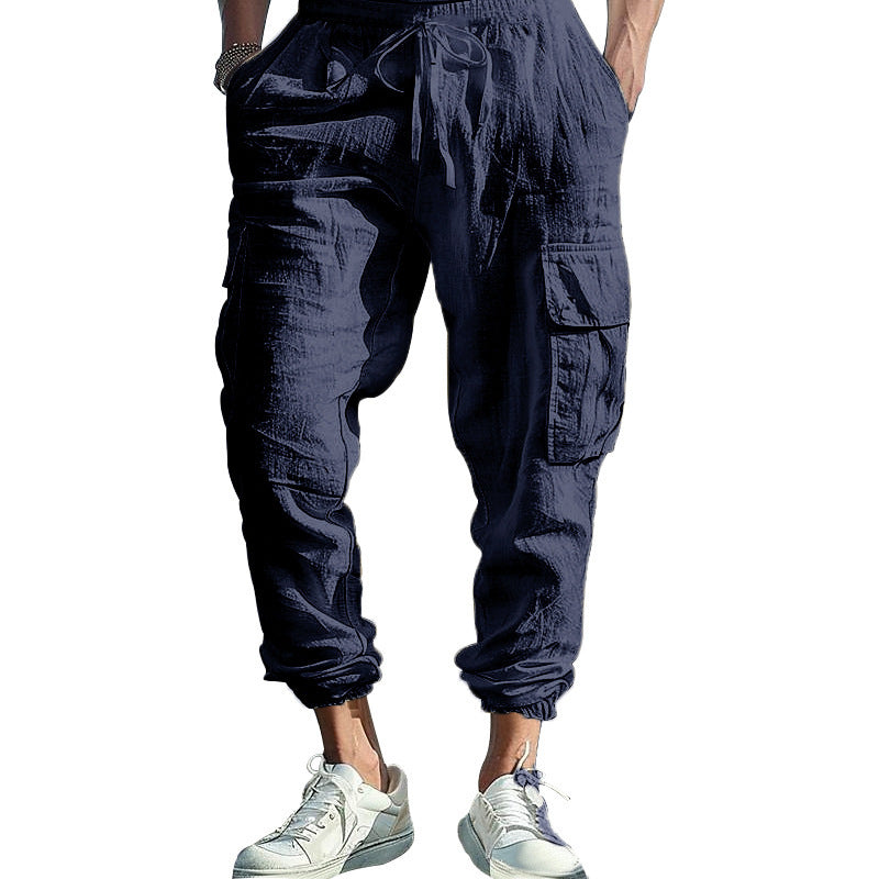 Navy blue cargo pants worn by a person on a white background
