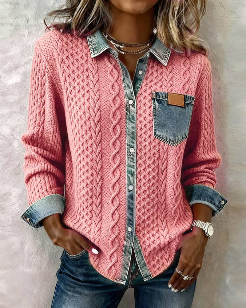 Person wearing a pink cable knit cardigan over a denim shirt with a neutral background