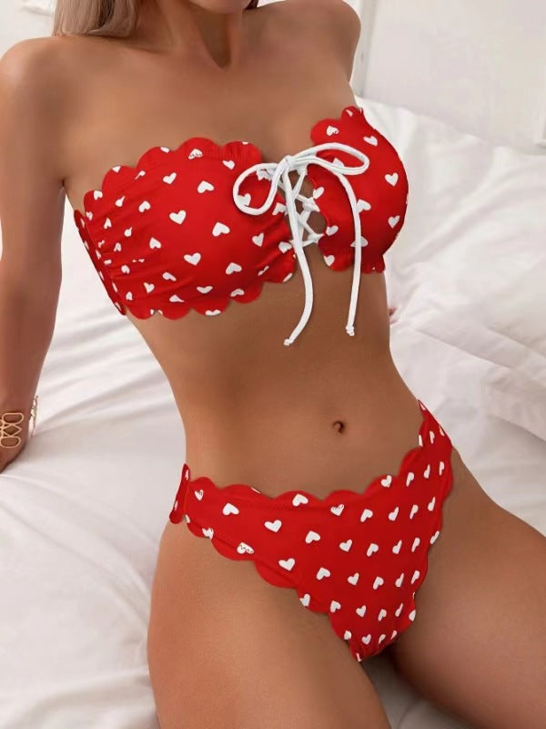 Red bikini with white heart patterns on a white background