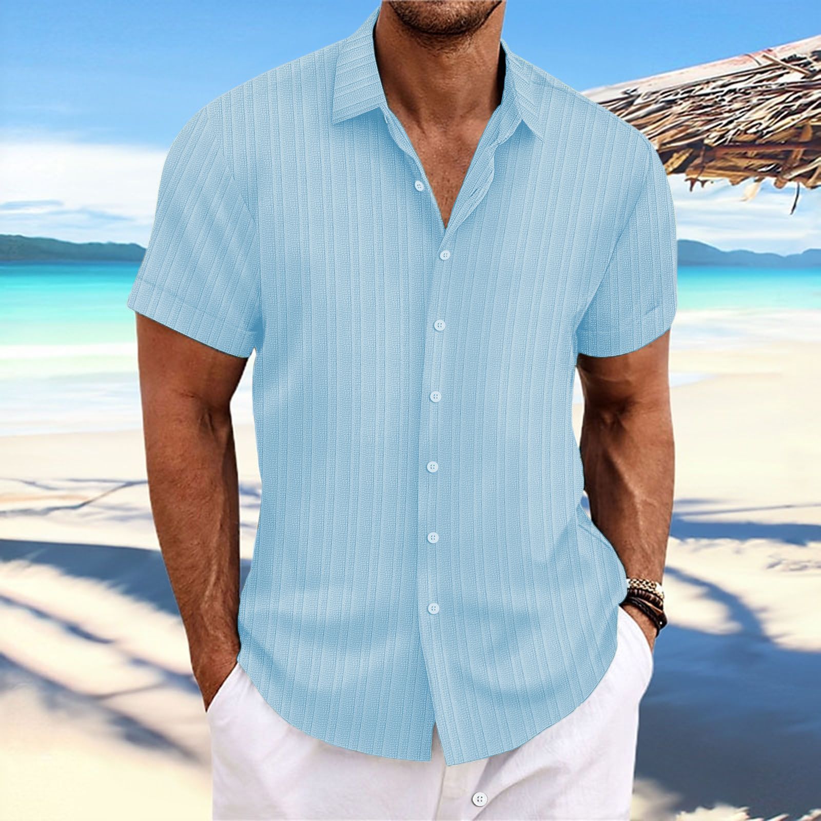 Man wearing a light blue striped shirt on a beach