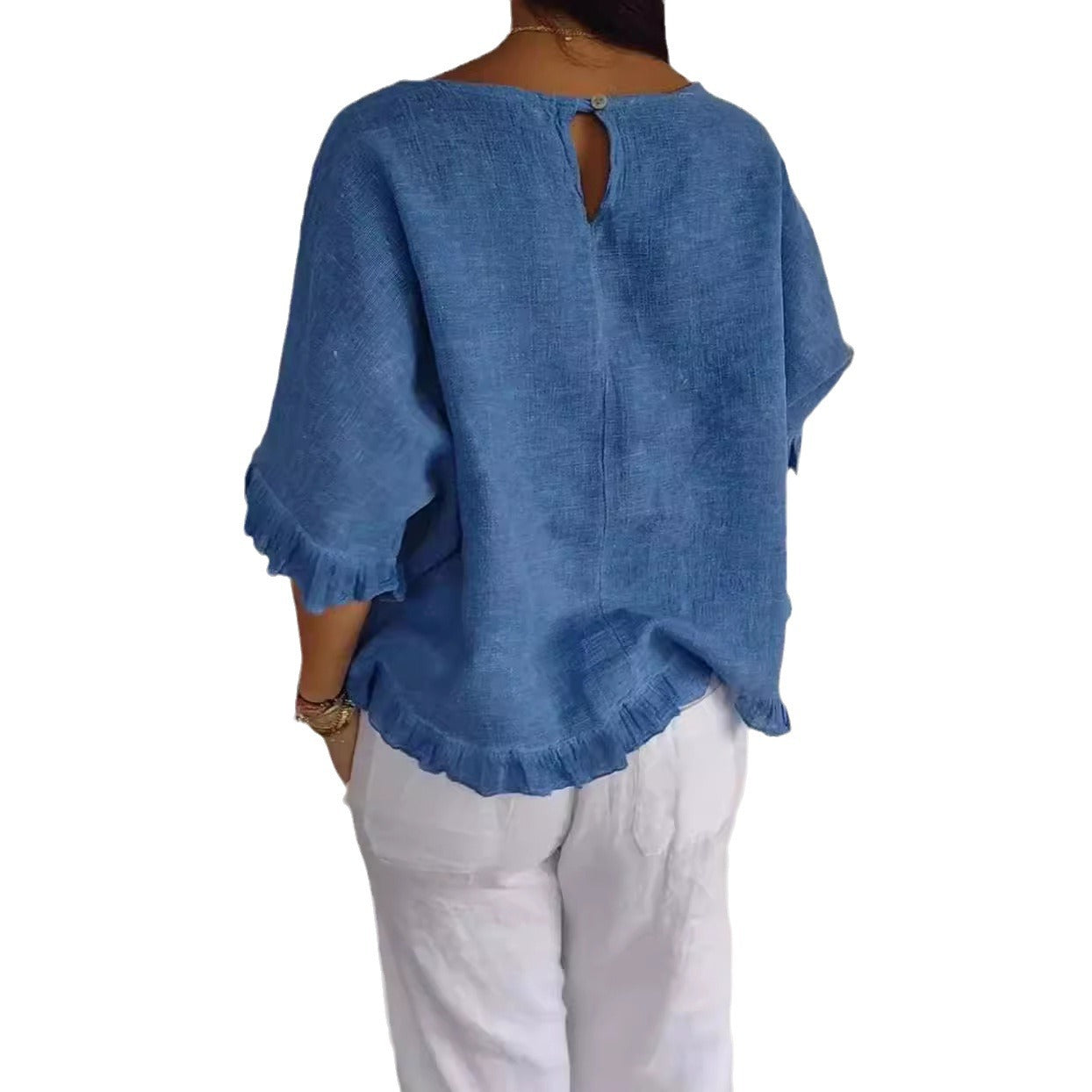 Blue linen top worn by a person on a white background