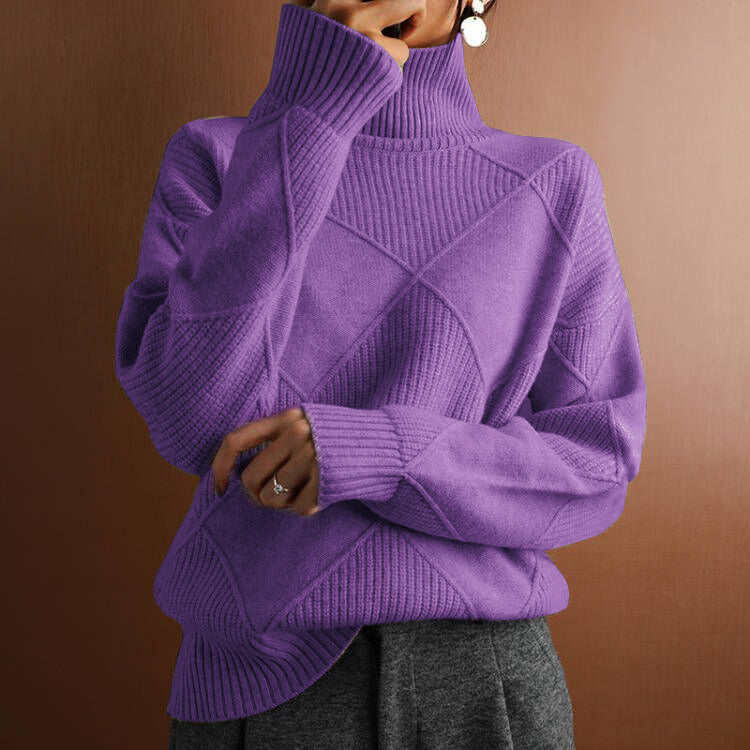Person wearing a purple turtleneck sweater against a brown background