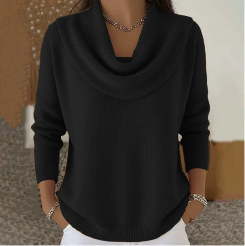 Black sweater worn by a person with a neutral background