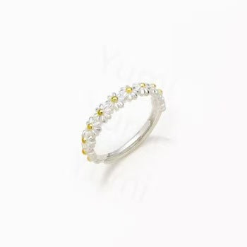 Silver ring with small pearls on a white background