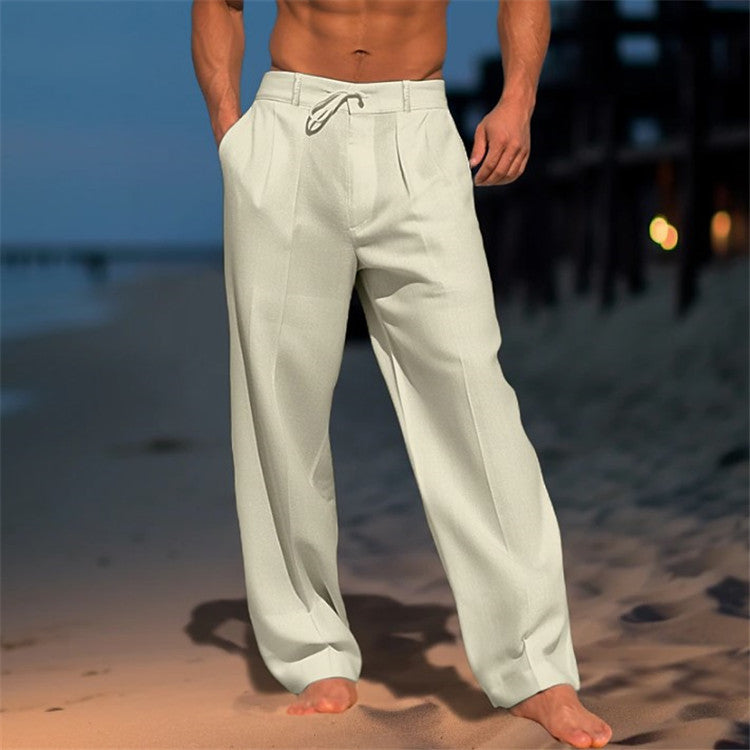 Person wearing light-colored pants on a beach at dusk