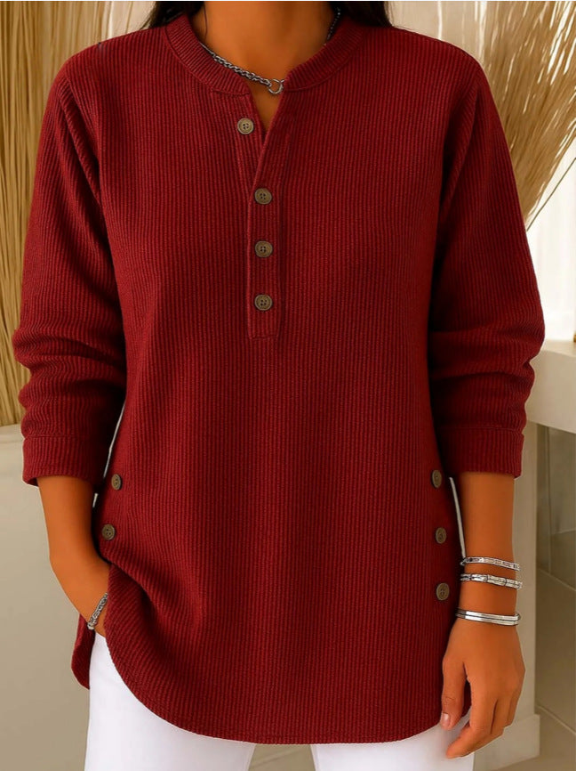 Red ribbed sweater worn by a person with a neutral background