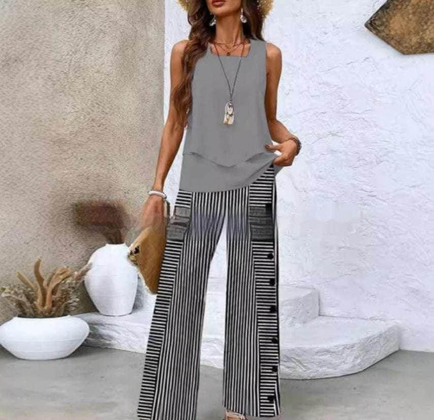 Woman in a grey sleeveless top and black and white striped wide-leg pants, ZA-Zola fashion