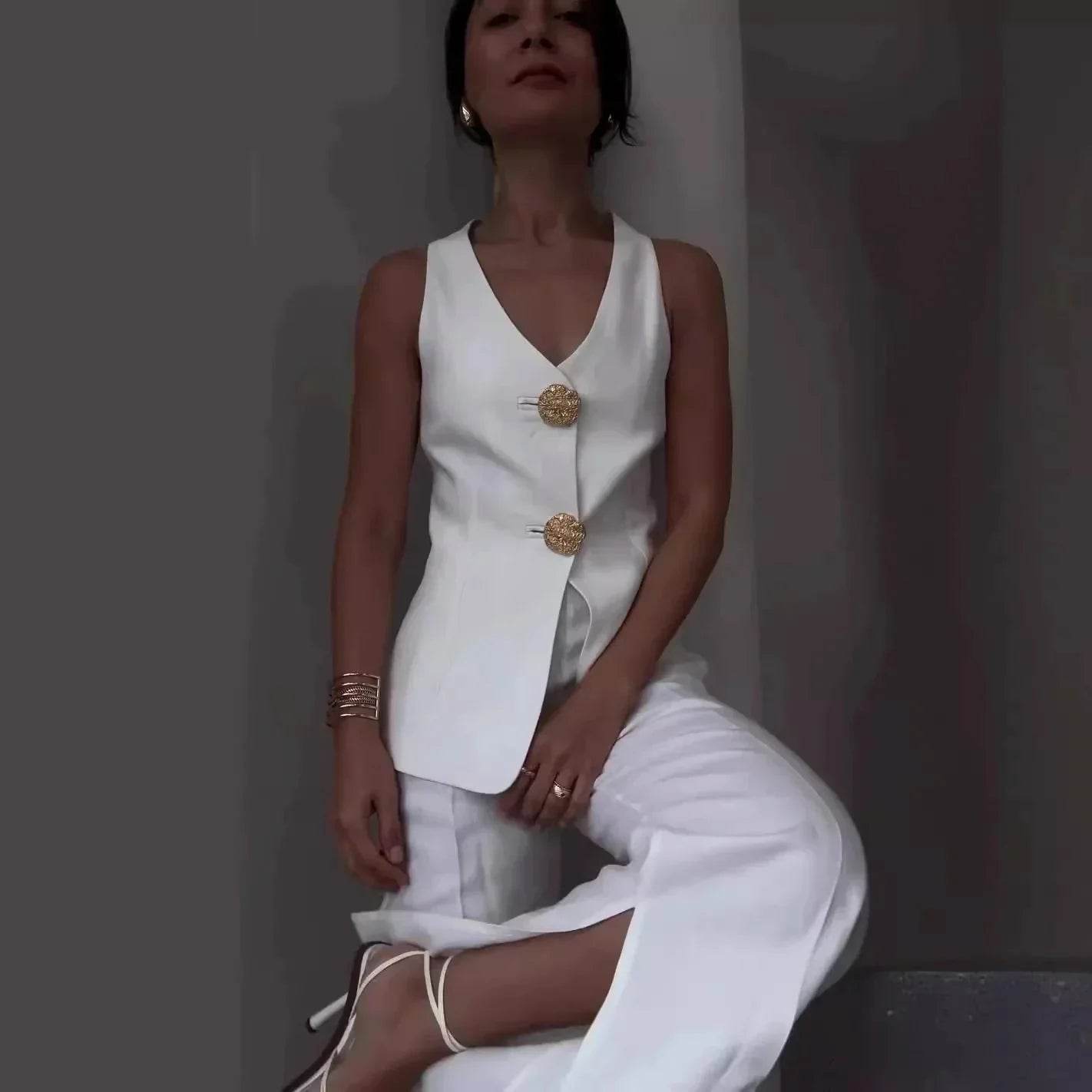 Woman modeling chic white vest and pants set with gold buttons, ZA-Zola fashion UK
