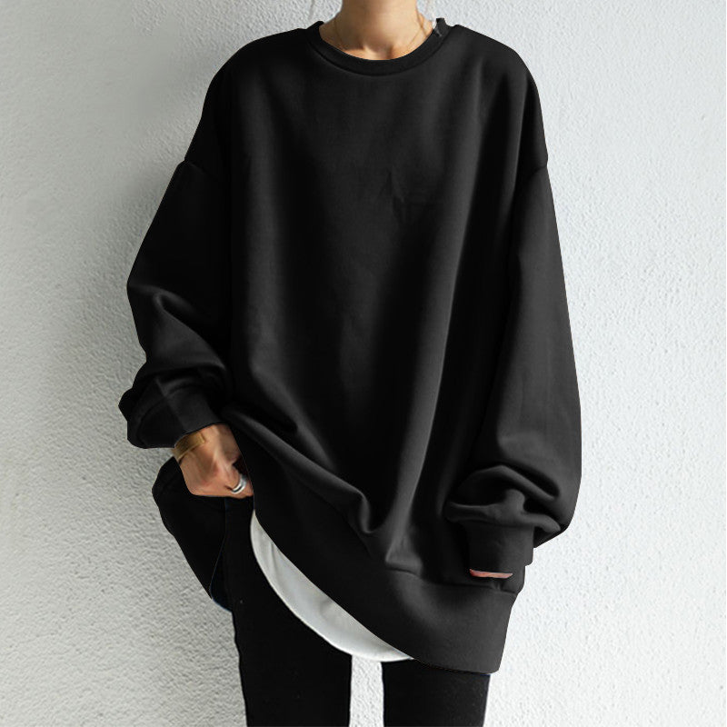 Black oversized sweatshirt worn by a person against a light gray background