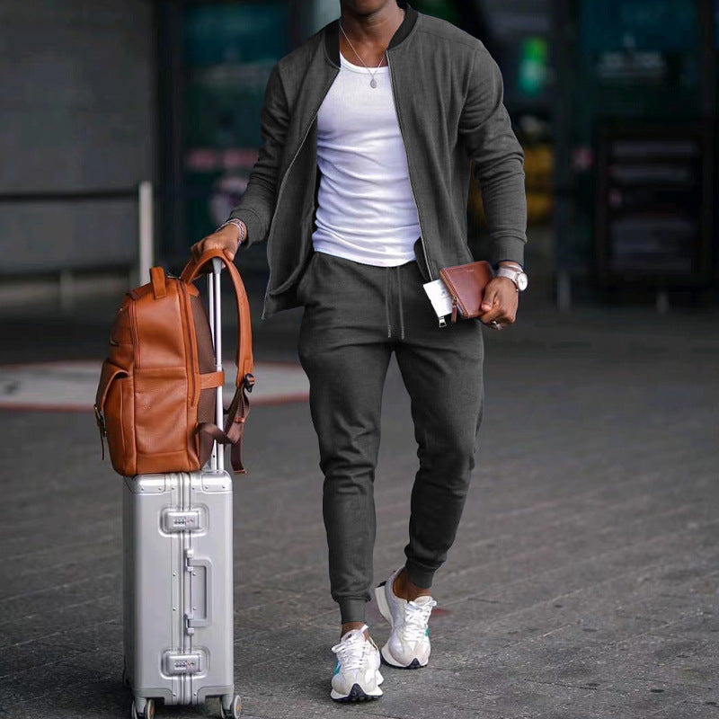 Man walking with a suitcase and brown backpack in an urban setting