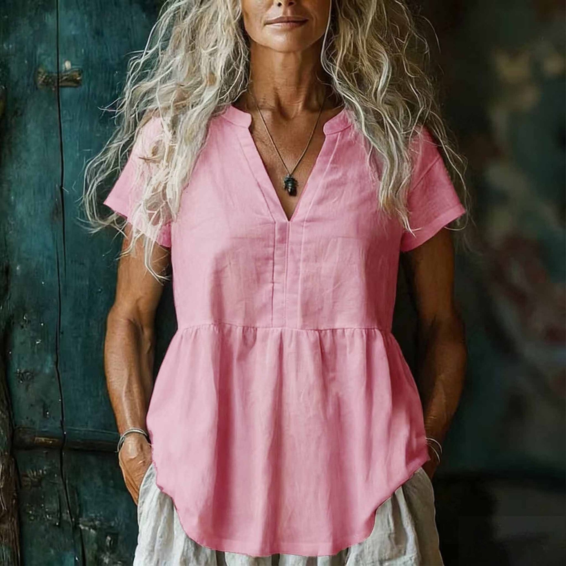 Woman wearing a pink top with a blurred background